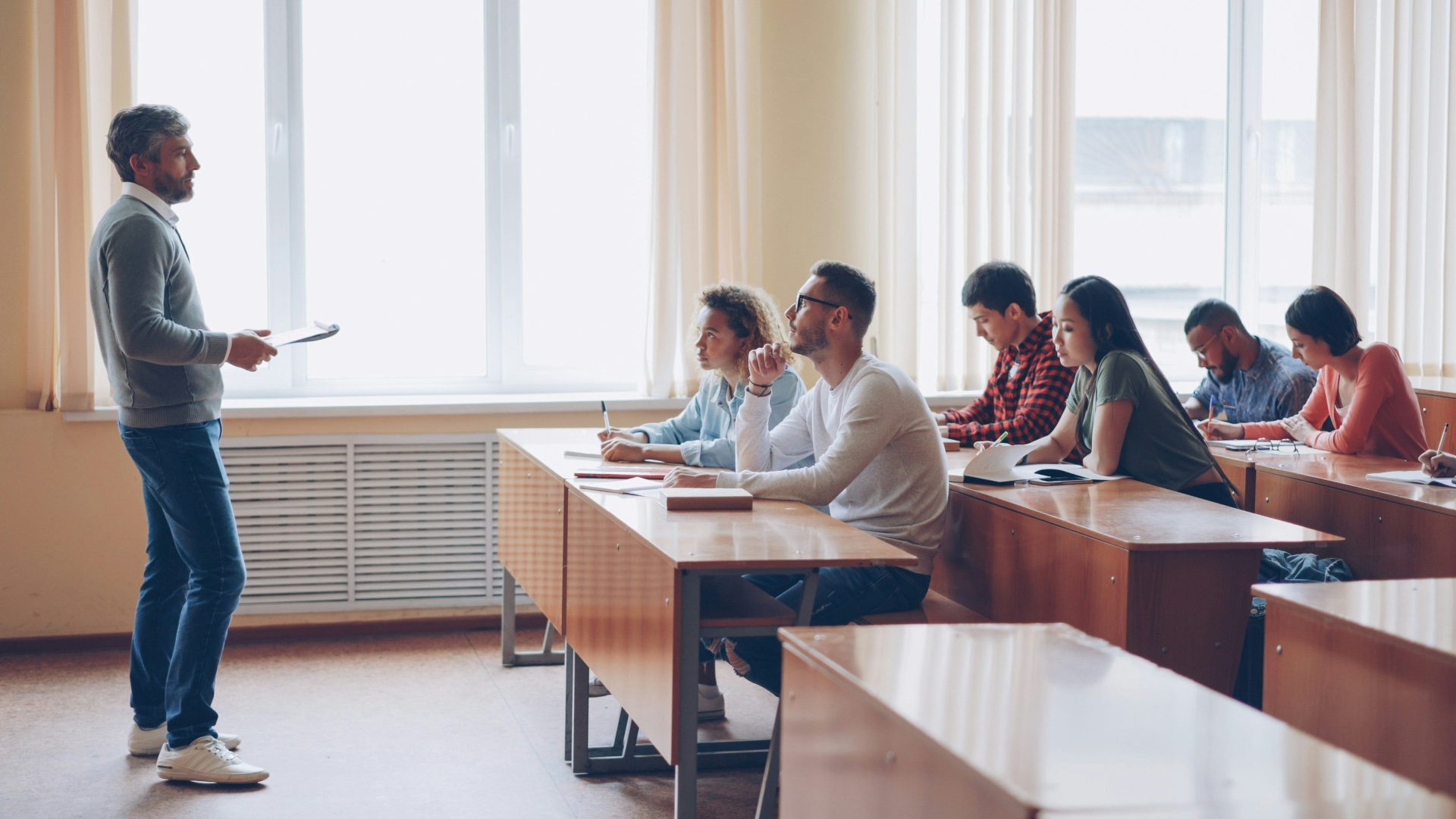 Teacher instructing students in a classroom lecture